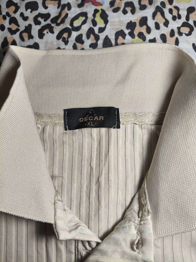 Men's Cream Short-Sleeve Ribbed Polo (Category: Tshirts & Polo Shirts ) located in Lapu Lapu. Submitted by hooman422 (Listing ID 1465072082, Image 3). Description: • Color: Cream / Off-white / Beige • Material/Texture: Vertical ribbed knit texture • Neckline: Stand collar (mandarin/band style) with a three-button placket closure • Fit/Style: Casual, modern minimal, or "old money style" aesthetic.