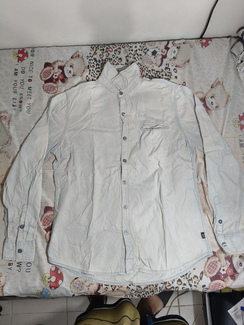 Men's Light Denim Shirt (Category: Coats, Jackets and Outerwear) located in Lapu Lapu. Submitted by hooman422 (Listing ID 1465074294, Image 1). Description: • Light wash denim shirt with long sleeves. • Mandarin collar style buttoned all the way up. • Single welt pocket on the left chest. • Contrast stitching details along the seams and button placket. • Rounded shirttail hem at the bottom..