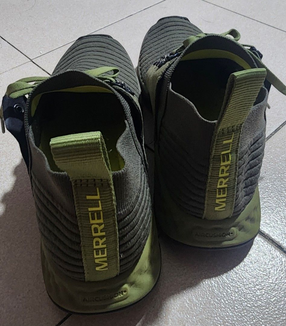 Merrell Olive Green Hiking Sneakers (Category: Sneakers) located in Manila. Submitted by chichayako (Listing ID 1465030923, Image 3). Description: - Brand/Model: Merrell Sneakers - Color: Olive Green - Material: Ribbed knit uppers with suede overlays - Design: Lace-up with metallic eyelets and heel pull tabs - Comfort & Grip: Cushioned soles with geometric tread pattern - Condition: Overall solid condition with minor wear on the outsoles.