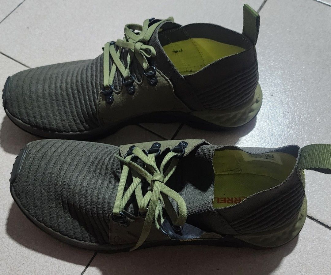 Merrell Olive Green Hiking Sneakers (Category: Sneakers) located in Manila. Submitted by chichayako (Listing ID 1465030923, Image 2). Description: - Brand/Model: Merrell Sneakers - Color: Olive Green - Material: Ribbed knit uppers with suede overlays - Design: Lace-up with metallic eyelets and heel pull tabs - Comfort & Grip: Cushioned soles with geometric tread pattern - Condition: Overall solid condition with minor wear on the outsoles.