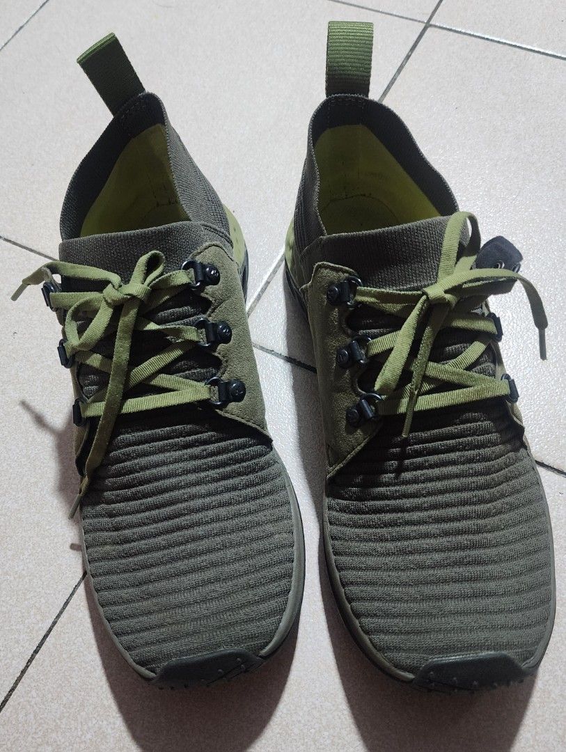 Merrell Olive Green Hiking Sneakers (Category: Sneakers) located in Manila. Submitted by chichayako (Listing ID 1465030923, Image 1). Description: - Brand/Model: Merrell Sneakers - Color: Olive Green - Material: Ribbed knit uppers with suede overlays - Design: Lace-up with metallic eyelets and heel pull tabs - Comfort & Grip: Cushioned soles with geometric tread pattern - Condition: Overall solid condition with minor wear on the outsoles.