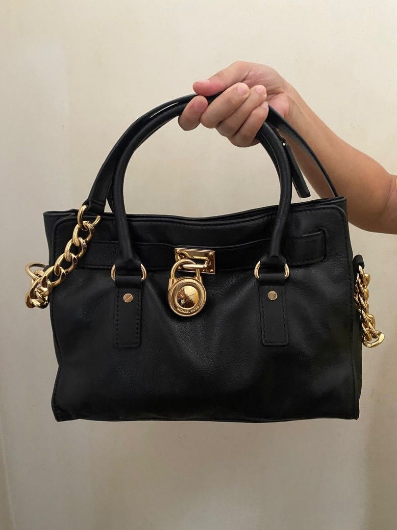 Michael Kors Hamilton Shoulder Bag / Satchel (Authentic) (Category: Shoulder Bags) located in Quezon City. Submitted by mp_simplefinds (Listing ID 1465096362, Image 3). Description: Condition: Excellent / Well-conditioned (No scratches, clean leather, and gold hardware is still shiny) Color: Black with Gold-tone hardware Details: Perfect for everyday use or office bag Very spacious and holds its shape well 100% authentic PM me for more actual pho