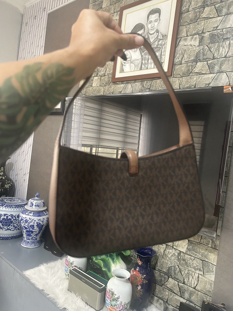 Michael Kors Lyra Brown Shoulder Bag (Category: Shoulder Bags) located in Dapitan. Submitted by loadserq (Listing ID 1464983520, Image 2). Description: - Authentic Michael Kors Lyra bag - Brown monogram canvas with tan leather strap and trim - Elegant gold-tone hardware featuring a lock charm and key chain - Pristine, clean condition inside and out - Brand new with retail tag still attached (Original Price: $398.00) -negotiable .