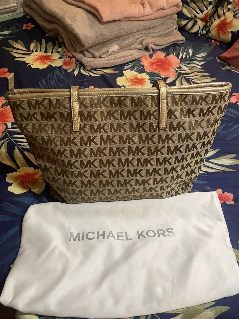 Michael Kors MK Monogram Tote Bag with Dust Bag (Category: Tote Bags) located in Badoc. Submitted by ganalgeral12718 (Listing ID 1465128590, Image 1). Description: - Brand: Michael Kors - Design: Signature MK monogram canvas with gold leather trim - Closure: Secure zip-top closure - Pockets: Outer zippered pocket, multiple interior slip pockets, and one inner zip compartment - Inclusions: Original white Michael Kors dust bag - Condition: Clean in