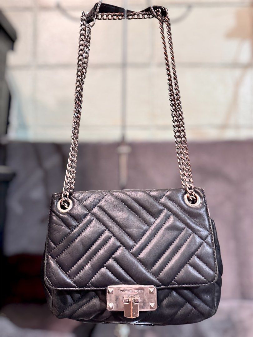 Michael Kors Quilted Leather Chain Shoulder Bag Black (Category: Luxury Bags & Wallets) located in Manila. Submitted by dearpinkcollections (Listing ID 1465094465, Image 1). Description: - Brand: Michael Kors - Material: Black quilted leather with chic diagonal chevron stitching - Hardware: Silver chain straps threaded with black leather - Closure: Front flap with engraved brand logo flip-lock - Interior: Clean and compact, perfect for daily esse
