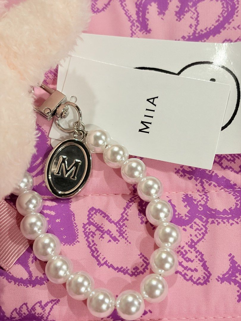 MIIA Miffy Plush Keyring with Pearl Strap (Category: Plushies & Soft Toys) located in Caloocan City. Submitted by miffuph (Listing ID 1465127404, Image 3). Description: - Brand: MIIA - Item: Fluffy bunny plush keychain - Outfit: Pink leopard print dress with a large bow on the back - Accessories: White pearl strap handle and branded silver charm tag - Condition: Brand new with original tags still attached.