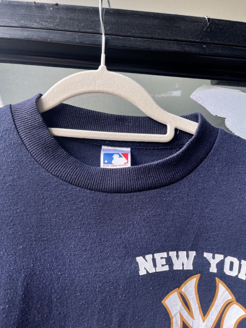 MLB New York Yankees Navy Blue Sweatshirt (Category: Coats, Jackets and Outerwear) located in Manila. Submitted by kingjamessthriftt (Listing ID 1465015663, Image 3). Description: - Official MLB New York Yankees crewneck sweatshirt - Color: Navy blue with white and gold team chest graphic - Material: Comfortable standard fit cotton blend - Details: Long sleeves, ribbed cuffs and hem - Authenticity: Features official Major League Baseball neck tag