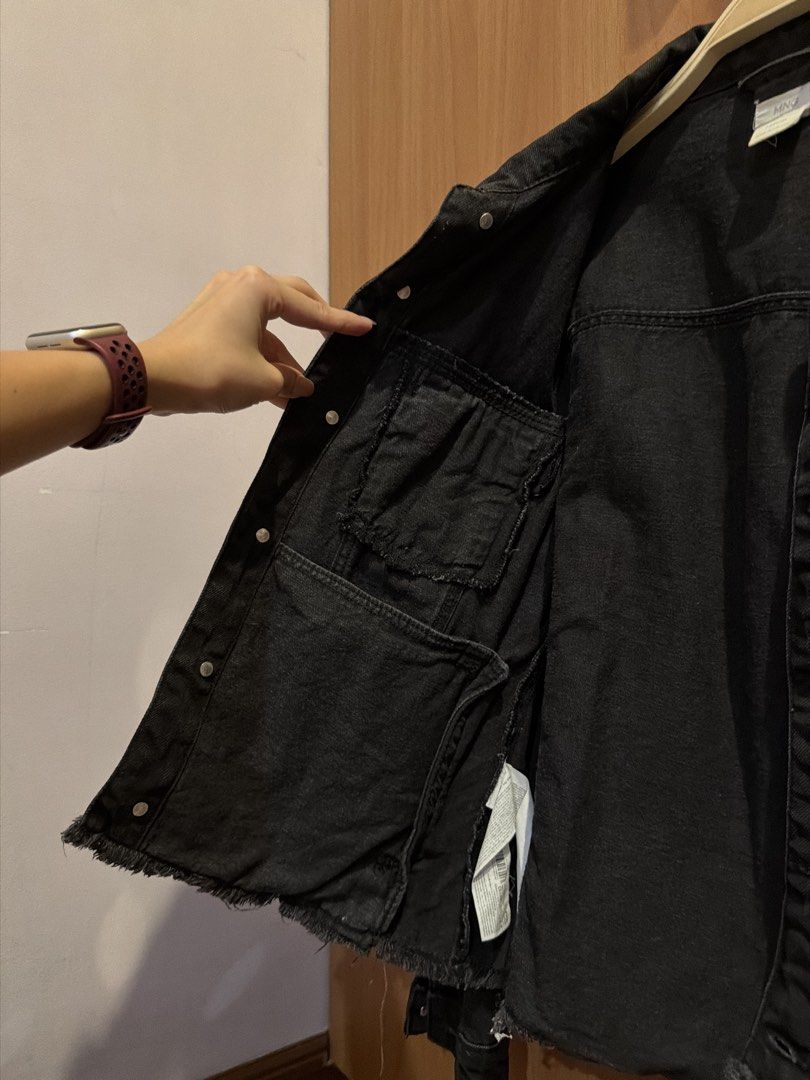 MNG Mango Black Denim Jacket (Category: Coats, Jackets and Outerwear) located in Quezon City. Submitted by hellopucca (Listing ID 1465088506, Image 3). Description: - Brand: MNG Kids - Fits adult size XS-S - Size: 13/14 years (164cm) - Has inside pockets both sides - Color: Classic black wash - Design: Button-up front with chest pockets and raw hem detail - Origin: Made in Pakistan - Condition: Excellent, easy layering piece for tees and hoodies.