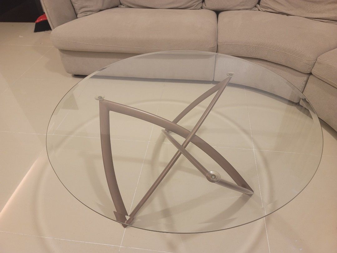 Modern Round Glass Coffee Table with Metallic Legs (Category: Tables & Sets) located in Manila. Submitted by kamilleale02863 (Listing ID 1465143605, Image 1). Description: - Contemporary round coffee table with clean lines - Thick, durable clear glass top secured with suction cups - Elegant curved metallic base in a bronze/taupe finish - Perfectly sized for in front of sofas or sectionals - Easy to disassemble and move with a removable glass top 