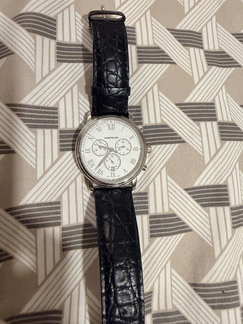 Montblanc Tradition Chronograph Watch (Category: Luxury Watches) located in Manila. Submitted by jack81472 (Listing ID 1465080431, Image 1). Description: - Brand: Montblanc Tradition Chronograph - Dial: White dial with classic Roman numerals, multiple sub-dials, and a bottom date window - Strap: Premium black embossed leather strap - Case & Hardware: Stainless steel case back with circular logo engraving and silver-tone crown/pushers - Condition: