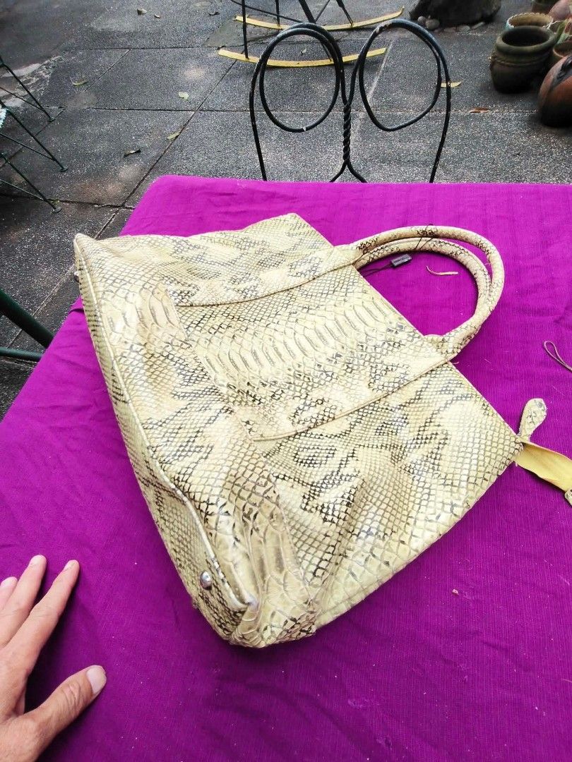 Monte Rosso Python Snake Skin Pattern Tote Handbag (Category: Tote Bags) located in Caloocan City. Submitted by kaymatias (Listing ID 1464989448, Image 1). Description: - Brand: Monte Rosso - Design: Eye-catching yellow and cream python snake skin pattern - Closure: Secure zipper top for the main compartment - Features: Dual top carry handles, protective bottom studs - Interior: Beige fabric lining with a zippered pocket and brand logo tag - Cond