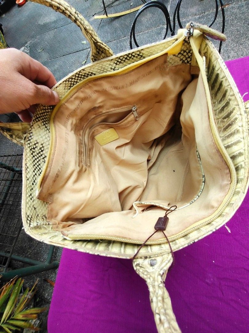 Monte Rosso Python Snake Skin Pattern Tote Handbag (Category: Tote Bags) located in Caloocan City. Submitted by kaymatias (Listing ID 1464989448, Image 3). Description: - Brand: Monte Rosso - Design: Eye-catching yellow and cream python snake skin pattern - Closure: Secure zipper top for the main compartment - Features: Dual top carry handles, protective bottom studs - Interior: Beige fabric lining with a zippered pocket and brand logo tag - Cond