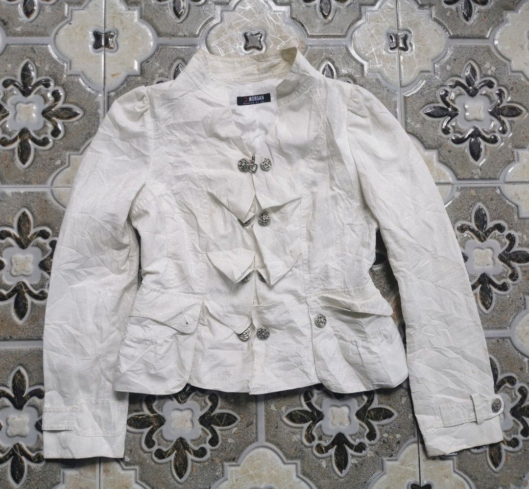 Morgan De Toi White Textured Jacket (Category: Coats, Jackets and Outerwear) located in Davao. Submitted by dmp1993 (Listing ID 1465037223, Image 1). Description: White textured jacket from Morgan De Toi. Decorative silver buttons down the front, including a heart-shaped top button. Puffed shoulders and flared peplum hem. Structured collar and buttoned cuff straps. Lined interior. Size 88-97-160 indicated on the tag..
