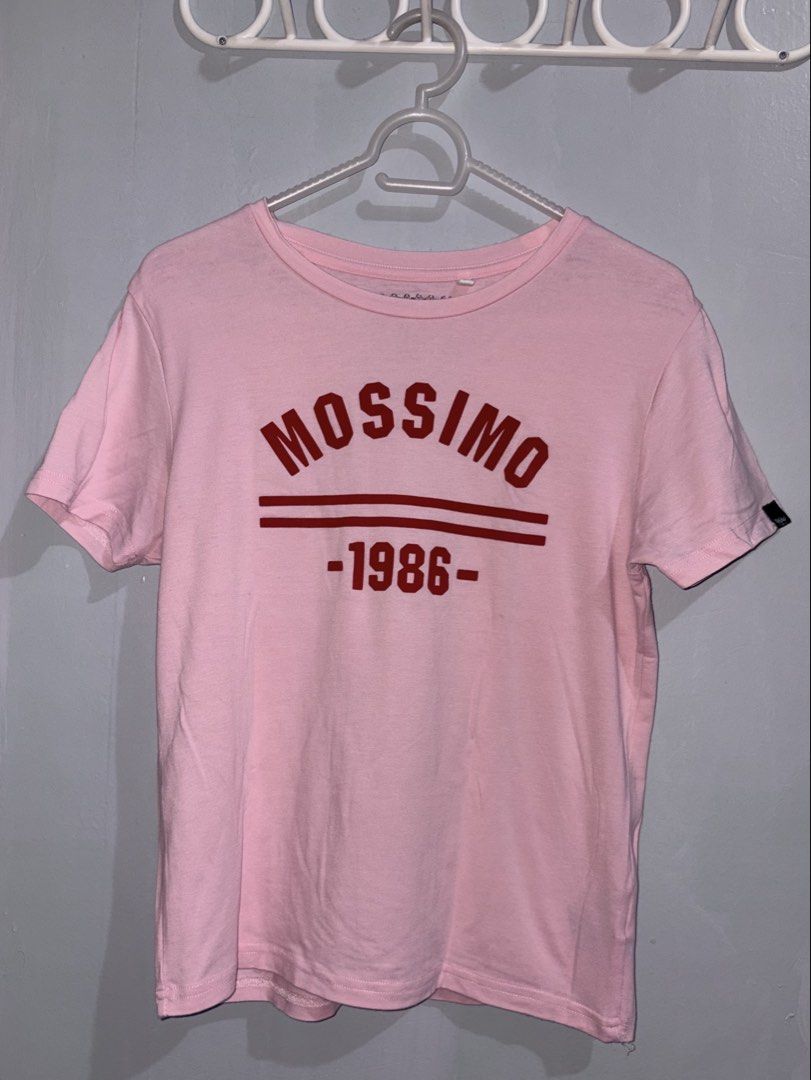 Mossimo 1986 Pink Baby Tee Medium (Category: Shirts) located in Manila. Submitted by margascloset_ (Listing ID 1465061495, Image 1). Description: - Pink | Medium - Design: Red printed 'MOSSIMO 1986' graphic - Details: Small black woven Mossimo logo tag on the left sleeve, printed collar tag - Fit: Short sleeves, round neckline RFS: Decluttering / no longer used MOD: J&t, LBC, Lalamove, Grab MOP: Gcash / Bank.