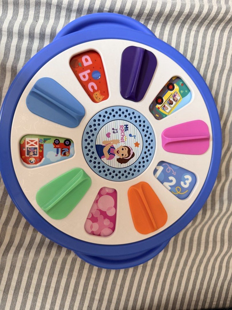 Ms. Rachel Surprise Learning Wheel Toy (Category: Educational & Learning Toys) located in Quezon City. Submitted by orinds (Listing ID 1464979445, Image 2). Description: - Official Ms. Rachel interactive learning toy for toddlers - Features colorful sliding tabs on both sides - Teaches colors, numbers, alphabet, and fun animal sounds - Built-in speaker with clear audio - Battery-operated (requires AAA batteries) - Great activity toy to keep littl