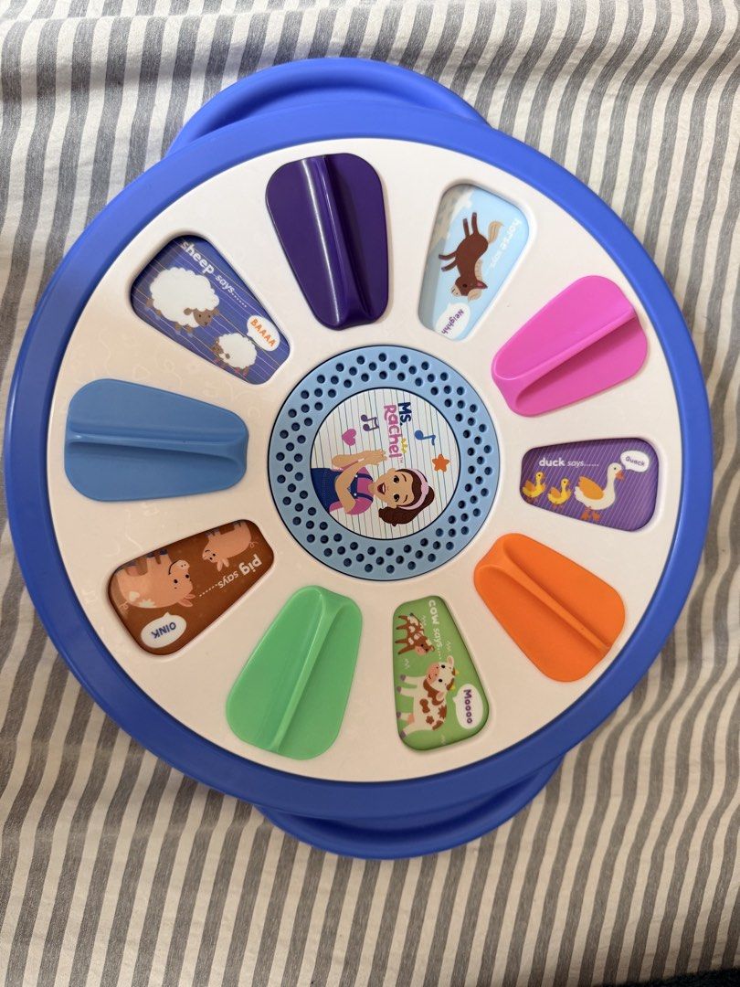 Ms. Rachel Surprise Learning Wheel Toy (Category: Educational & Learning Toys) located in Quezon City. Submitted by orinds (Listing ID 1464979445, Image 3). Description: - Official Ms. Rachel interactive learning toy for toddlers - Features colorful sliding tabs on both sides - Teaches colors, numbers, alphabet, and fun animal sounds - Built-in speaker with clear audio - Battery-operated (requires AAA batteries) - Great activity toy to keep littl