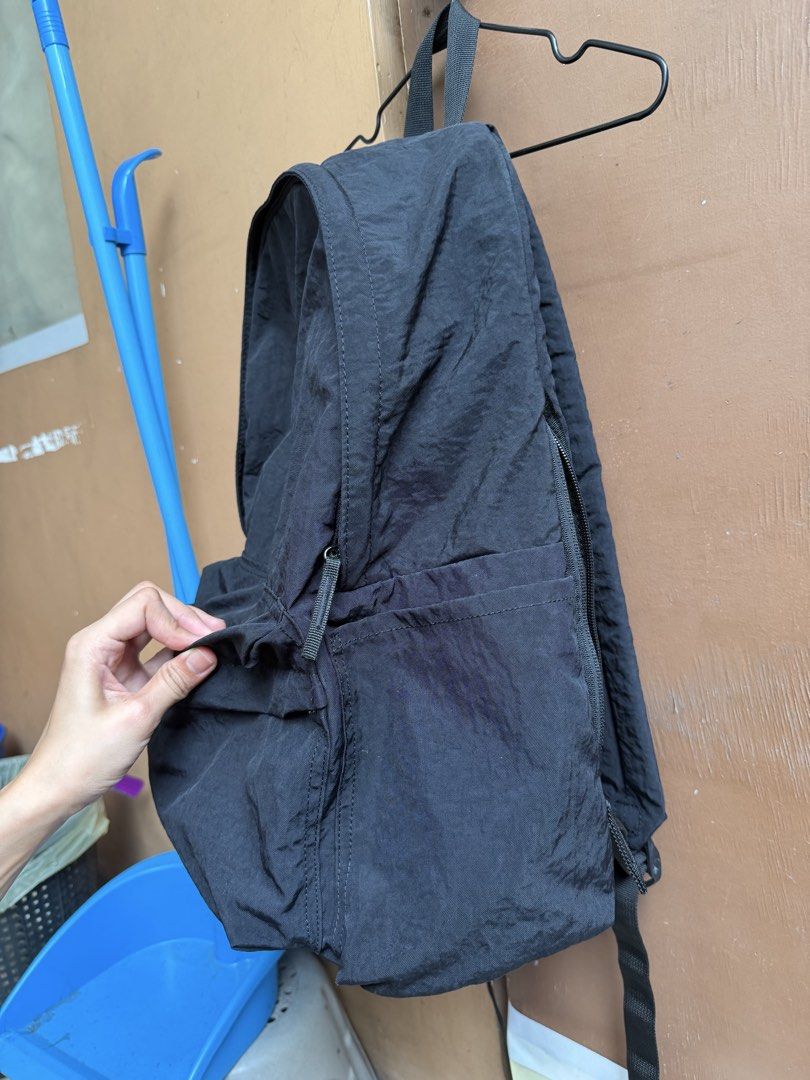 MUJI Black Nylon Backpack with Front Pocket (Category: Backpacks) located in Paranaque City. Submitted by mryjwll (Listing ID 1465169892, Image 3). Description: Simple black nylon backpack with a zippered front pocket and side slip pockets. Main compartment opens wide with sturdy zippers. Lightweight fabric with a crinkled texture. Adjustable shoulder straps on the back. Clean interior and exterior, ready for daily use, school, or travel. Neutral