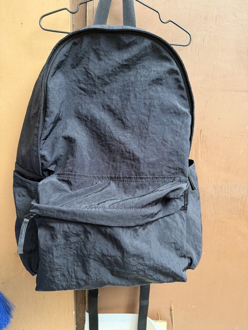 MUJI Black Nylon Backpack with Front Pocket (Category: Backpacks) located in Paranaque City. Submitted by mryjwll (Listing ID 1465169892, Image 1). Description: Simple black nylon backpack with a zippered front pocket and side slip pockets. Main compartment opens wide with sturdy zippers. Lightweight fabric with a crinkled texture. Adjustable shoulder straps on the back. Clean interior and exterior, ready for daily use, school, or travel. Neutral