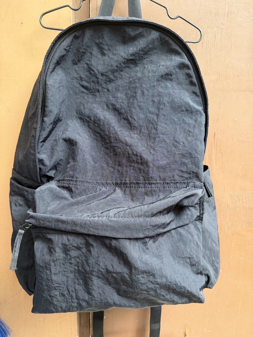 MUJI Black Nylon Backpack with Front Pocket (Category: Backpacks) located in Paranaque City. Submitted by mryjwll (Listing ID 1465169892, Image 2). Description: Simple black nylon backpack with a zippered front pocket and side slip pockets. Main compartment opens wide with sturdy zippers. Lightweight fabric with a crinkled texture. Adjustable shoulder straps on the back. Clean interior and exterior, ready for daily use, school, or travel. Neutral