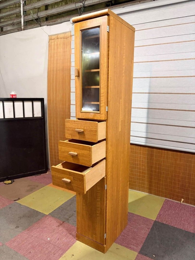 Multi purpose storage cabinet (Category: Shelves, Cabinets & Racks) located in Meycauayan. Submitted by marygracecasimiro (Listing ID 1465018001, Image 3). Description: Slim Multi-purpose Storage Cabinet Adjustable Shelves, with Drawers, MAKINIS!!! Tall, narrow wooden multi-functional storage cabinet featuring an upper glass-paneled door with interior shelving, three middle drawers with wooden pulls, and a lower cabinet door. Price : 5.5k ✅ 12L x