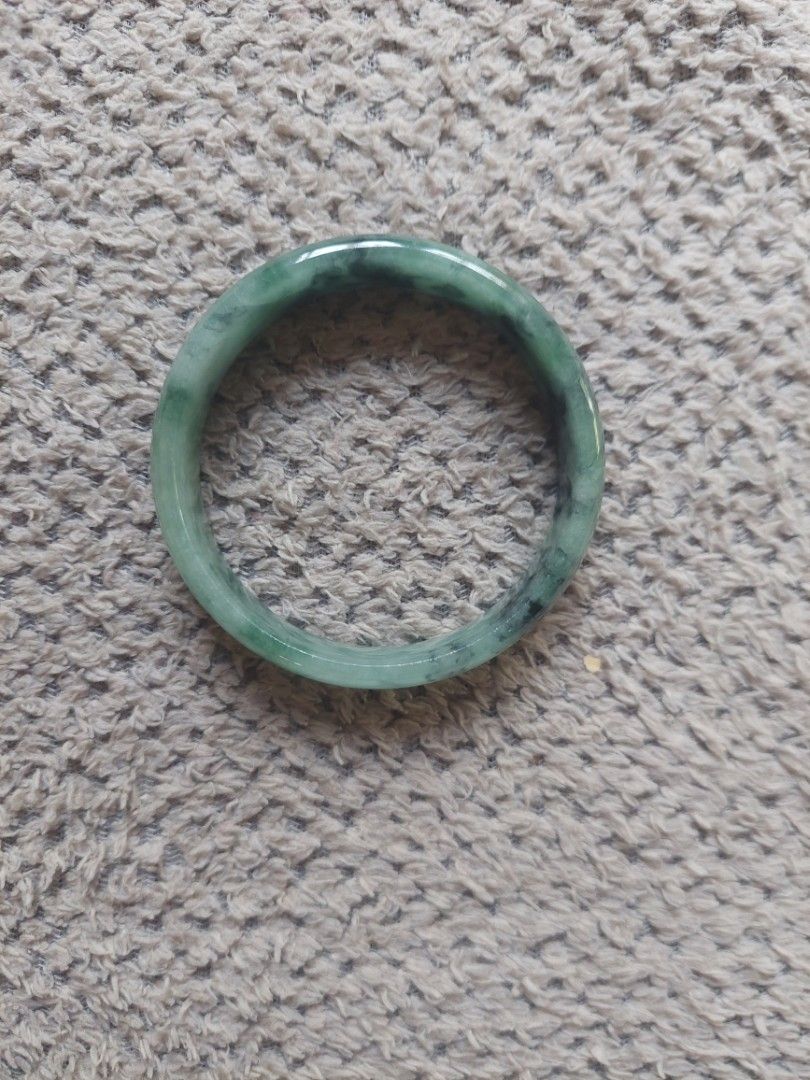 Natural green jadeite stone bangle bracelet (Category: Bracelets) located in Bulacan. Submitted by evangelion346 (Listing ID 1465047730, Image 2). Description: - Genuine green jade bangle with deep forest green patches and natural dark inclusions - Smooth, polished surface all around for a comfortable wear - Rounded profile with a comfortable inner diameter - Features unique natural stone variations throughout the piece - Versatile and classic ac