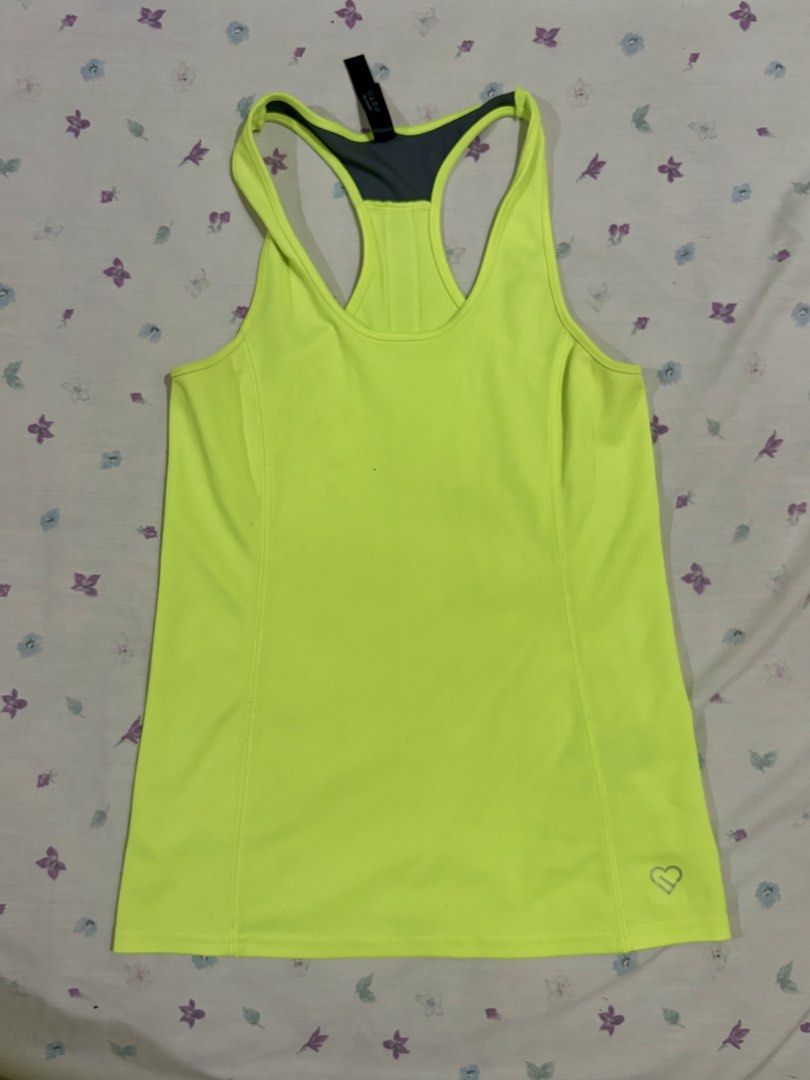 Neon yellow athletic racerback tank top (Category: Activewear) located in Mandaluyong City. Submitted by judened (Listing ID 1465035311, Image 1). Description: - Condition: Brand new with tags attached - Color: Bright neon yellow with grey and black/white accents - Design: Racerback with top grey contrast mesh and vertical back stripe - Material: Lightweight and breathable fabric ideal for workouts - Details: Features a cute small silver heart lo