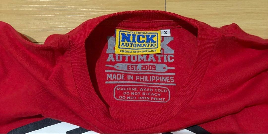 Nick Automatic Red Graphic T-Shirt Small (Category: Tshirts & Polo Shirts ) located in Quezon City. Submitted by garagesale2026 (Listing ID 1465124940, Image 2). Description: - Preloved - In good condition - Features a large graphic on the front with the brand name - Short sleeves and crew neck.