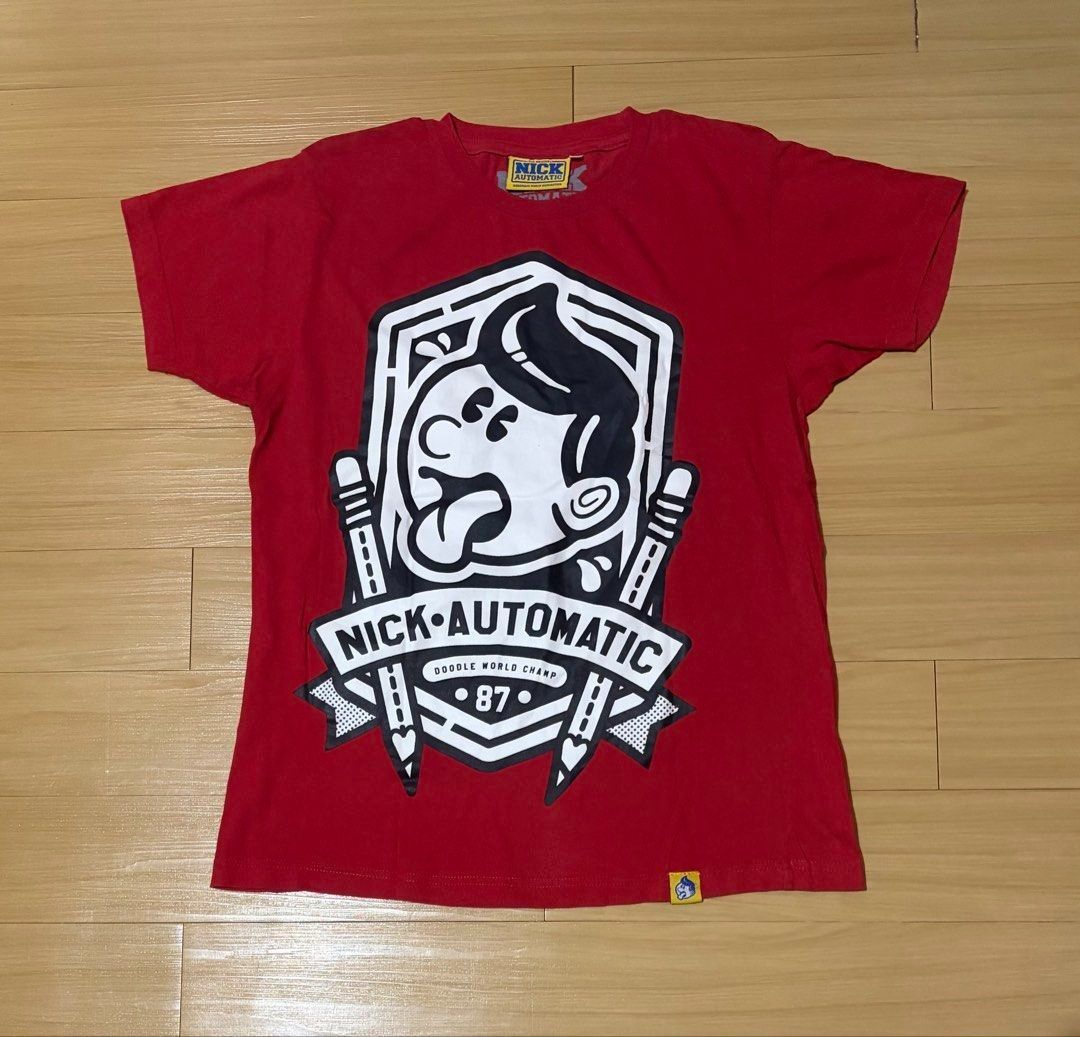 Nick Automatic Red Graphic T-Shirt Small (Category: Tshirts & Polo Shirts ) located in Quezon City. Submitted by garagesale2026 (Listing ID 1465124940, Image 1). Description: - Preloved - In good condition - Features a large graphic on the front with the brand name - Short sleeves and crew neck.