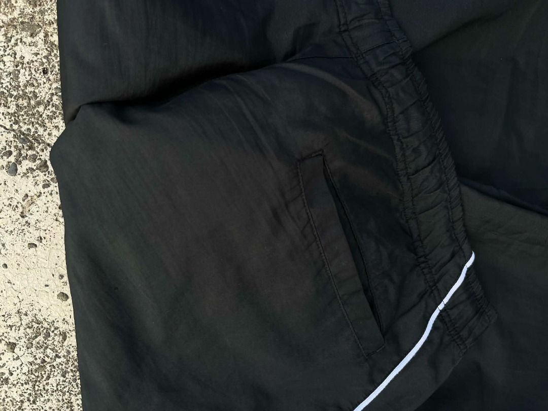 Nike Black Track Pants Men's Size L (Category: Joggers) located in Caloocan City. Submitted by wildmountain.b14159 (Listing ID 1465098306, Image 2). Description: - Brand: Nike - Color: Black with white side piping - Size: L (Tag attached) - Features: Elastic waistband, adjustable drawstring toggles at the hem, two side pockets, breathable mesh lining - Origin: Made in China - Condition: Brand new / Excellent.