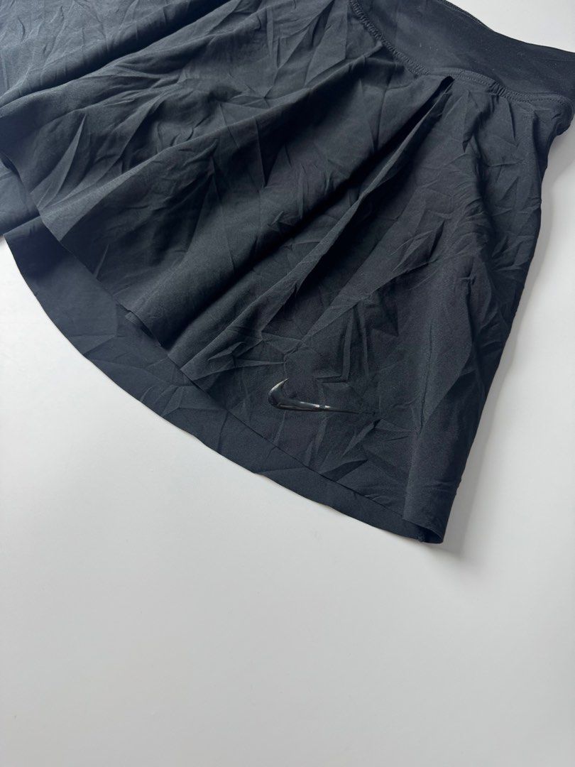 Nike Dri-FIT Black Pleated Athletic Skort (Category: Skirts) located in Manila. Submitted by babygirly2k (Listing ID 1465081443, Image 2). Description: - Brand: Nike - Item: Athletic Skort - Color: Black - Size: Extra Small (XS) - Material: Polyester and spandex blend with Dri-FIT moisture-wicking technology - Features: Built-in shorts with side pocket, reflective stripe detail, and pleated skirt design - Origin: Made in Cambodia - Style Code: DB
