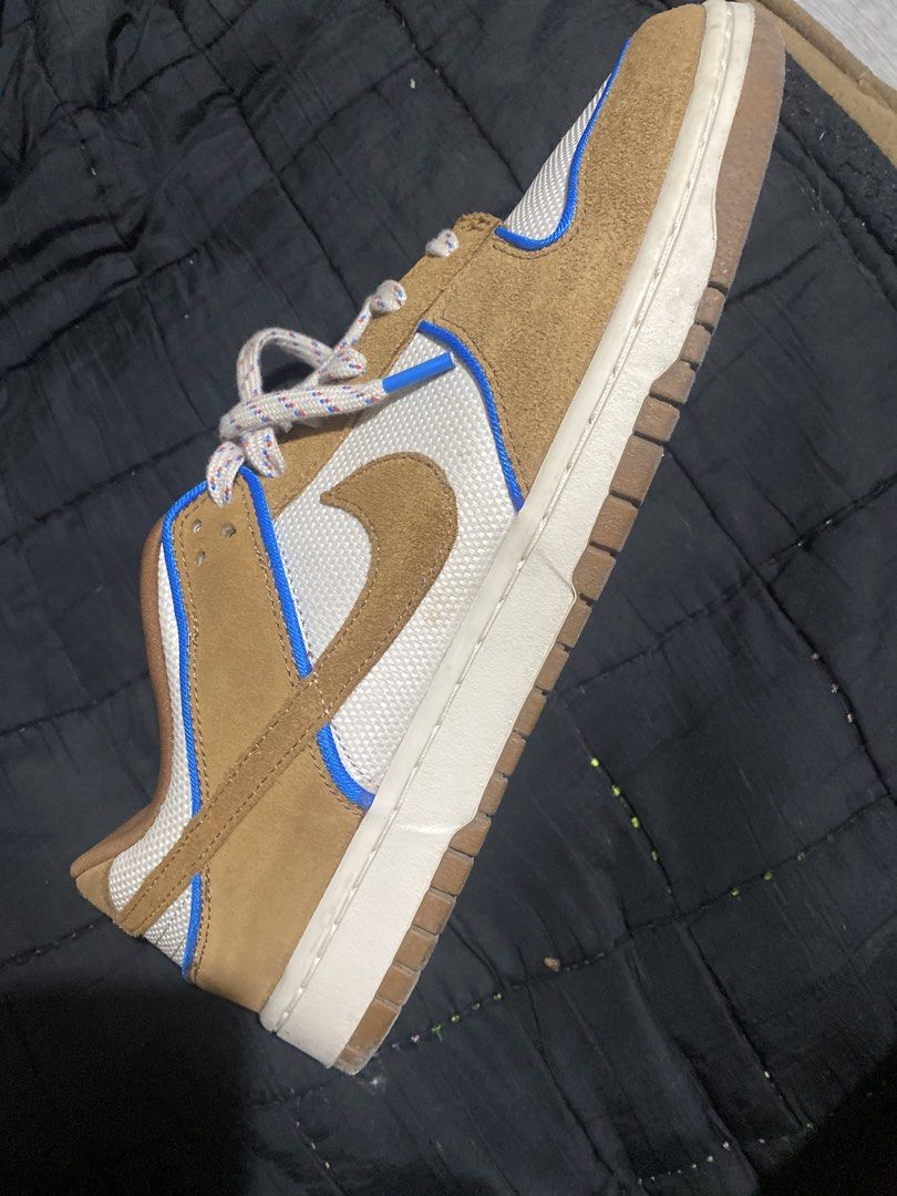 Nike Dunk Low Brown Blue White Sneakers (Category: Sneakers) located in Caloocan City. Submitted by true_johntan (Listing ID 1465093283, Image 1). Description: - Brand/Model: Nike Low-Top Skate Sneakers - Colorway: Brown, white, and blue with distinct blue piping - Materials: Premium suede overlays and breathable white mesh underlays - Details: Unique patterned rope laces with bright blue aglets, crisp white midsole, and durable gum rubber outsol