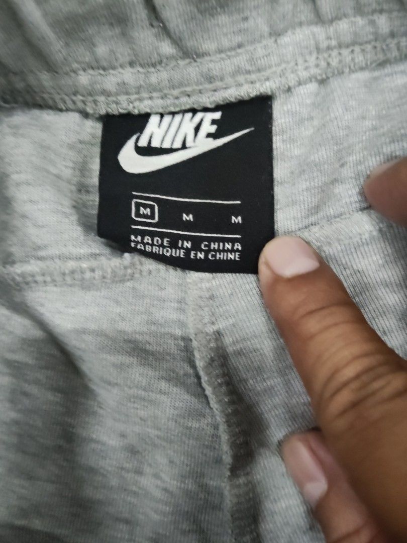 Nike Grey Tech Fleece Shorts Size M (Category: Shorts) located in Manila. Submitted by jepoy2026 (Listing ID 1465101083, Image 3). Description: - Brand: Nike - Color: Grey - Size: Medium (Tag: 80cm waist, 165-175cm height) - Material: Comfortable cotton and polyester blend - Waistband: Adjustable with black drawstrings - Storage: Convenient side zippered pocket on the left leg - Branding: Nike logo printed near the hem - Condition: Clean and well