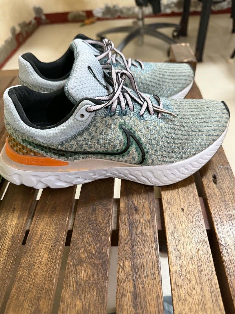 Nike Infinity React Run Women's Running Shoes Size US 7.5 (Category: Sneakers) located in Cabuyao City. Submitted by vastrabbit_07d2c0 (Listing ID 1465055174, Image 2). Description: - Model: Nike Infinity React Run (Style Code: DD3024-300) - Colorway: Grey and blue with vibrant orange heel accent - Size: US 7.5 / UK 5 / EUR 38.5 / 24.5 cm - Origin: Made in Vietnam - Features: Textured knit upper, patterned laces, and plush white cushioned foam so