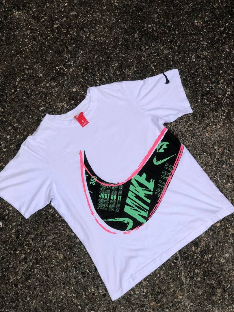 Nike Just Do It Graphic Tee (Category: Tshirts & Polo Shirts ) located in Tacloban City. Submitted by thedropout (Listing ID 1465051561, Image 1). Description: - Brand: Nike - Style: Graphic t-shirt - Size: Medium - Color: White - Details: Big multi-color swoosh logo with neon green 'Just Do It' text on the front - Sleeve: Small black swoosh printed on the left sleeve - Fit/Material: Classic crew neck, clean cotton build - Condition: Easy everyda