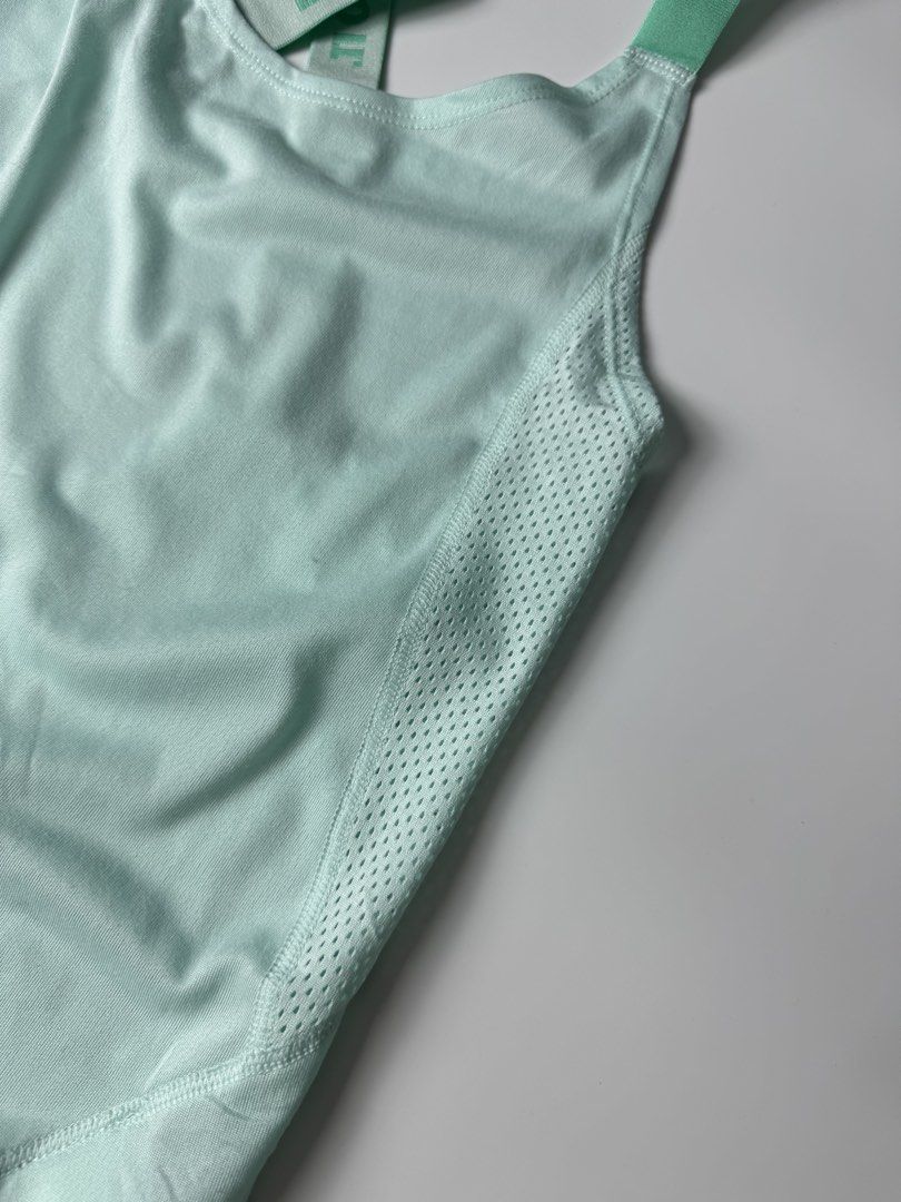 Nike Mint Green Just Do It Workout Tank Top (Category: Activewear) located in Manila. Submitted by babygirly2k (Listing ID 1465080248, Image 3). Description: - Brand: Nike - Color: Mint Green - Condition: Mint / Like New - Features: Breathable side mesh panels for extra ventilation - Design: Stylish crisscross back straps with 'JUST DO IT' print - Details: Small Nike swoosh logo on front hem and high-low curved hemline - Material: Lightweight and