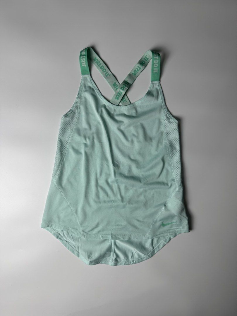 Nike Mint Green Just Do It Workout Tank Top (Category: Activewear) located in Manila. Submitted by babygirly2k (Listing ID 1465080248, Image 1). Description: - Brand: Nike - Color: Mint Green - Condition: Mint / Like New - Features: Breathable side mesh panels for extra ventilation - Design: Stylish crisscross back straps with 'JUST DO IT' print - Details: Small Nike swoosh logo on front hem and high-low curved hemline - Material: Lightweight and