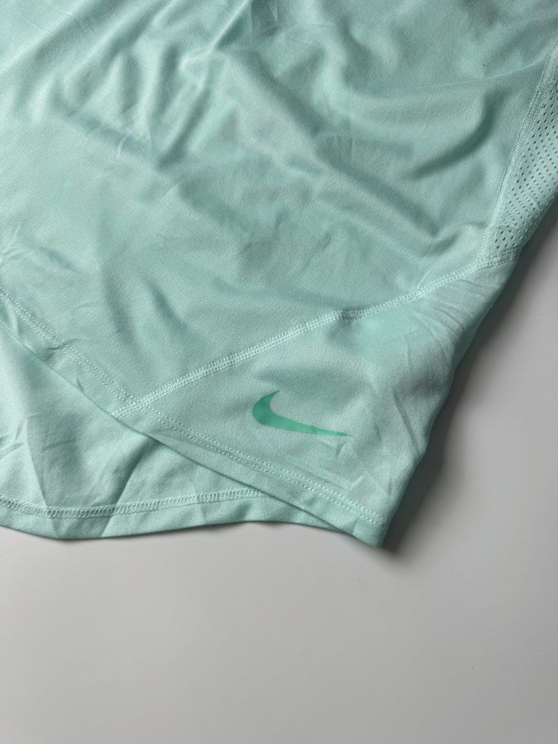 Nike Mint Green Just Do It Workout Tank Top (Category: Activewear) located in Manila. Submitted by babygirly2k (Listing ID 1465080248, Image 2). Description: - Brand: Nike - Color: Mint Green - Condition: Mint / Like New - Features: Breathable side mesh panels for extra ventilation - Design: Stylish crisscross back straps with 'JUST DO IT' print - Details: Small Nike swoosh logo on front hem and high-low curved hemline - Material: Lightweight and