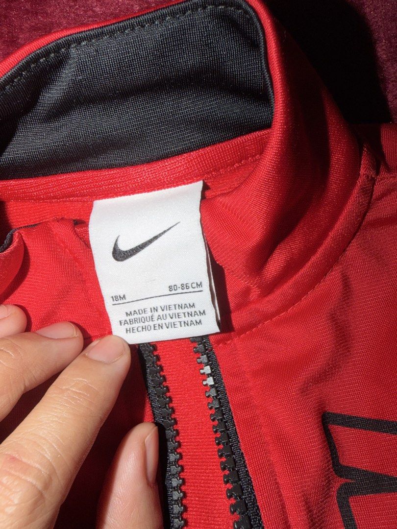 Nike Red Black Zip Up Jacket Kids 18M (Category: Babies & Kids Fashion) located in Manila. Submitted by karlaaricheta (Listing ID 1465080961, Image 2). Description: - Brand: Nike - Color: Red and black - Size: 18 months (80-86 cm) - Design: Stand collar, full front zip, vertical Nike lettering on chest, and two front pockets - Material: Soft athletic fabric - Condition: Excellent pre-loved condition - Perfect for sporty everyday wear.