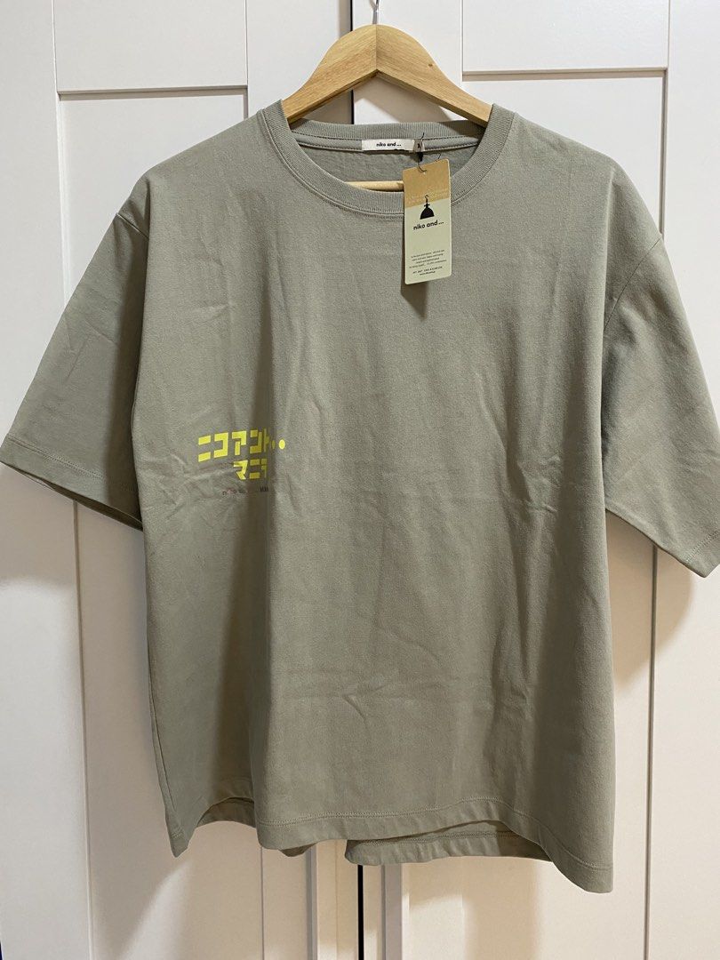 Niko and... Manila Olive Green Size M (Category: Tshirts & Polo Shirts ) located in Quezon City. Submitted by wearhouze (Listing ID 1465076072, Image 1). Description: - Brand: Niko and... - Color: Olive Green - Condition: Brand new with original tags attached - Material: 100% Cotton - Fit: Relaxed fit with short sleeves and ribbed crew neckline - Design: Japanese text on the front chest and diamond box graphic on the upper back.