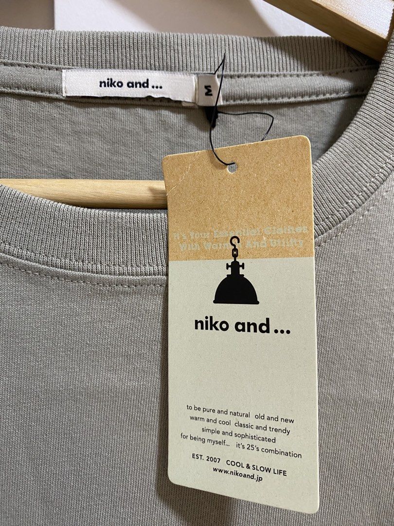 Niko and... Manila Olive Green Size M (Category: Tshirts & Polo Shirts ) located in Quezon City. Submitted by wearhouze (Listing ID 1465076072, Image 3). Description: - Brand: Niko and... - Color: Olive Green - Condition: Brand new with original tags attached - Material: 100% Cotton - Fit: Relaxed fit with short sleeves and ribbed crew neckline - Design: Japanese text on the front chest and diamond box graphic on the upper back.