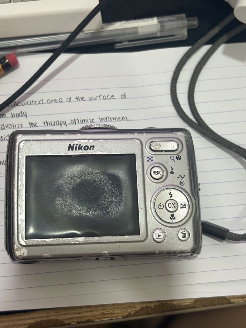 Nikon Coolpix P4 VR (Category: Cameras) located in Manila. Submitted by wohainie (Listing ID 1465070090, Image 2). Description: - Camera Model: Nikon Coolpix P4 VR point and shoot digital camera (Silver) - Lens: Built-in nikon 3.5x optical zoom lens - Condition: Heavy cosmetic wear, scuffs, paint chipping, and heavy marks on the LCD screen - Functionality: Powers on/off via top buttons and dial, tested working - Inclusions: Wrist strap attached -