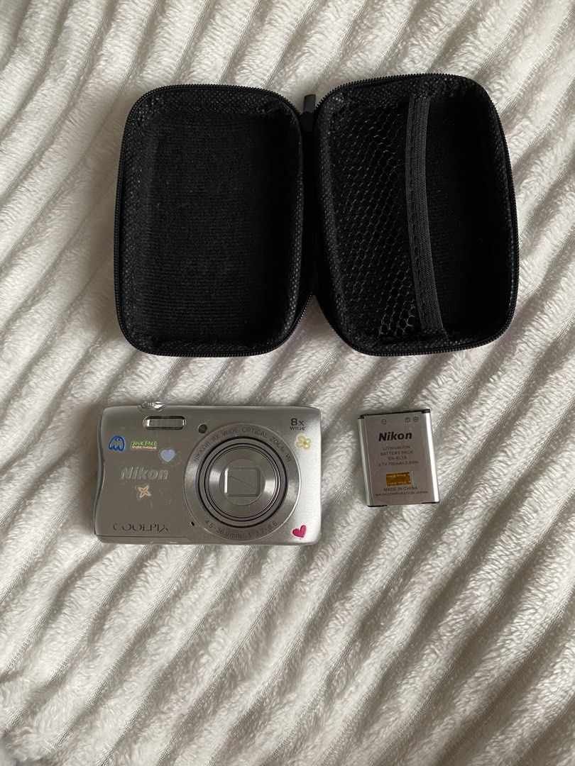 Nikon Coolpix S3700 Digital Camera with Battery and Case (Category: Cameras) located in Iloilo. Submitted by angelenepe01084 (Listing ID 1465098382, Image 1). Description: - Model: Silver Nikon Coolpix S3700 point and shoot camera - Aesthetic: Decorated with cute, fun stickers on the front and back - Ideal for: Vintage digital photography trend and everyday carry (EDC) - Inclusions: Nikon EN-EL19 rechargeable lithium-ion battery and a black zippe