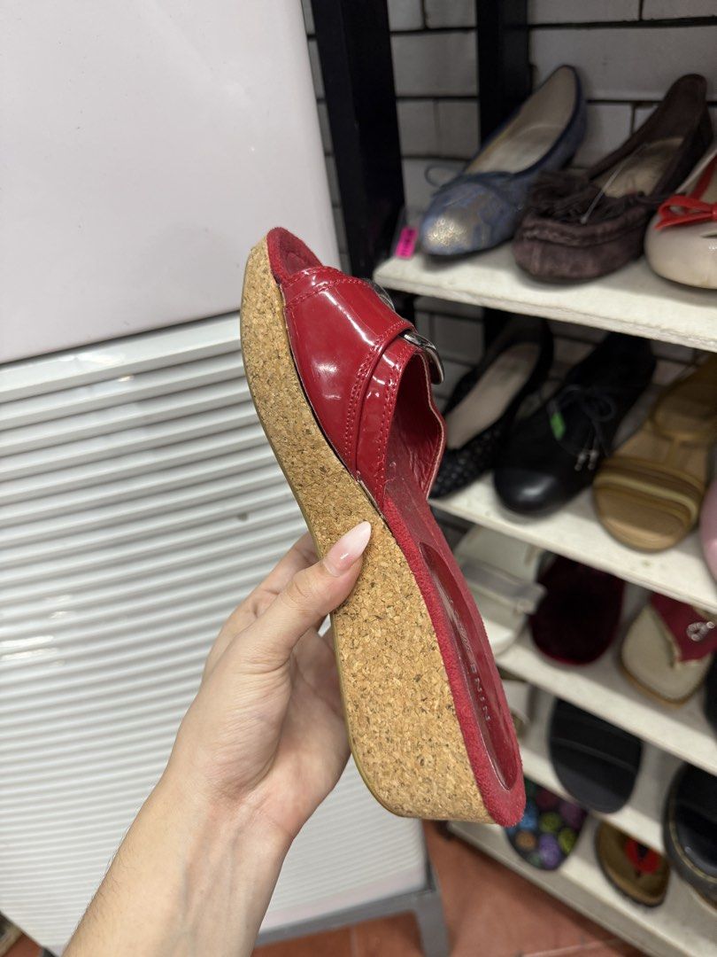 Nine West Red Wedge Sandals with Buckle (Category: Flats & Sandals) located in Manila. Submitted by fastlion.584bdf (Listing ID 1465068618, Image 3). Description: - Brand: Nine West - Style: Slip-on wedge sandals / slides - Material: Red patent leather with cork wedge and platform - Accents: Large silver-tone buckle on the front strap - Condition: Worn condition with some interior dust, still highly stylish and wearable - Perfect for casual outin