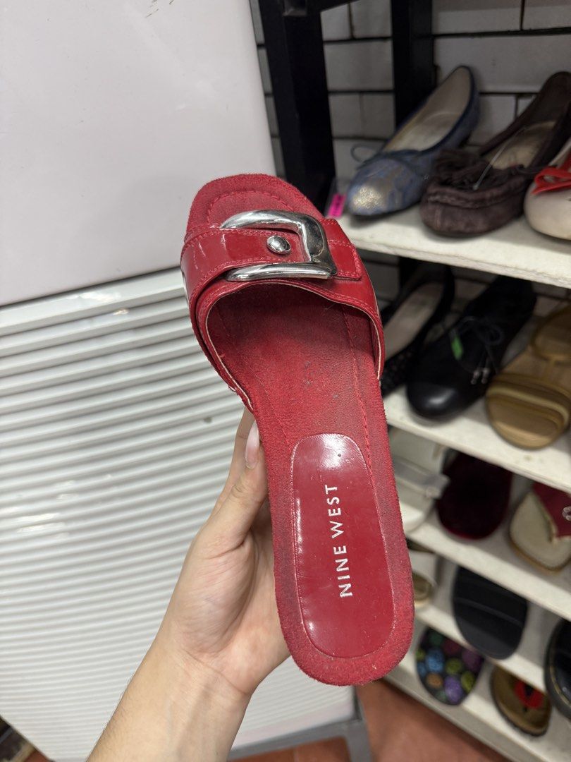Nine West Red Wedge Sandals with Buckle (Category: Flats & Sandals) located in Manila. Submitted by fastlion.584bdf (Listing ID 1465068618, Image 2). Description: - Brand: Nine West - Style: Slip-on wedge sandals / slides - Material: Red patent leather with cork wedge and platform - Accents: Large silver-tone buckle on the front strap - Condition: Worn condition with some interior dust, still highly stylish and wearable - Perfect for casual outin