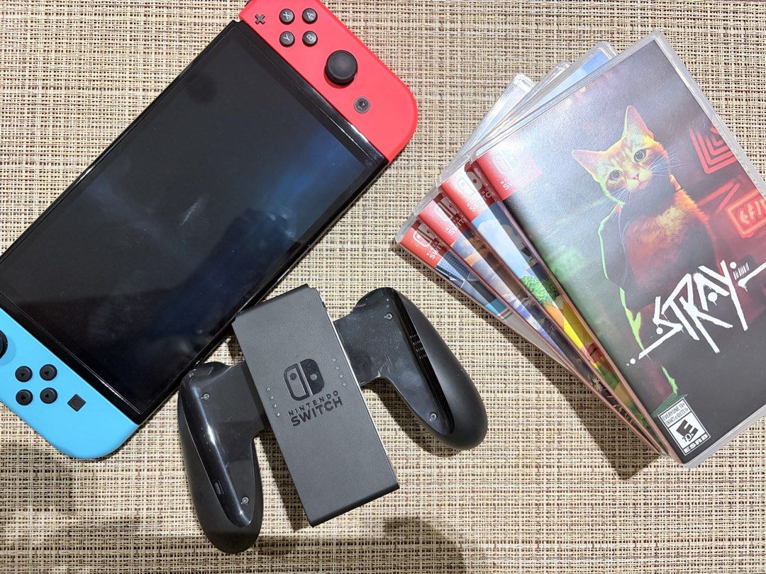Nintendo Switch OLED Console with Games (used for 3 months only) (Category: Nintendo) located in Makati City. Submitted by mmmicka (Listing ID 1465073322, Image 1). Description: - Nintendo Switch Console (Neon Red & Blue) - used for 3 months - complete accessories - 4 Physical Game Cartridges: Stray, Animal Crossing New Horizons, The Legend of Zelda Breath of the Wild, and Nintendo Switch Sports - Complete bundle, dock included - No scratch - Com