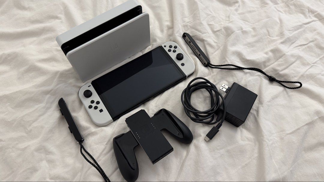 Nintendo Switch OLED Model White with Dock and Accessories (Category: Nintendo) located in Marikina City. Submitted by angel.archives (Listing ID 1465063562, Image 2). Description: NINTENDO SWITCH OLED WHITE - Nintendo Switch OLED White with white Joy-Cons - Original box - Dock, charger, and HDMI cable - Joy-Con grip and wrist straps - Black carrying case - Console carrying case - Dobe Pink console - No scratches and no repair history. Switch gam