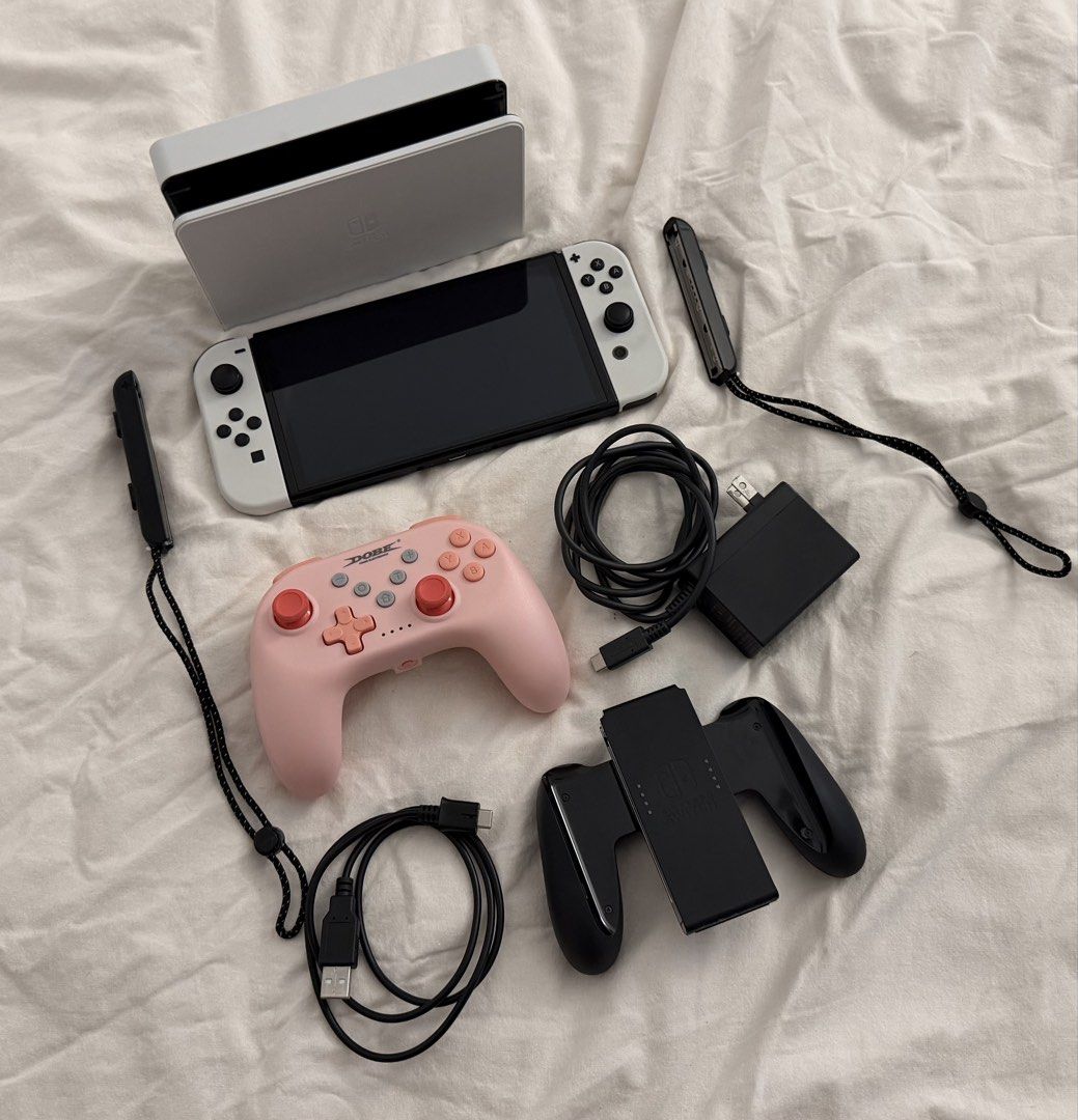 Nintendo Switch OLED Model White with Dock and Accessories (Category: Nintendo) located in Marikina City. Submitted by angel.archives (Listing ID 1465063562, Image 1). Description: NINTENDO SWITCH OLED WHITE - Nintendo Switch OLED White with white Joy-Cons - Original box - Dock, charger, and HDMI cable - Joy-Con grip and wrist straps - Black carrying case - Console carrying case - Dobe Pink console - No scratches and no repair history. Switch gam