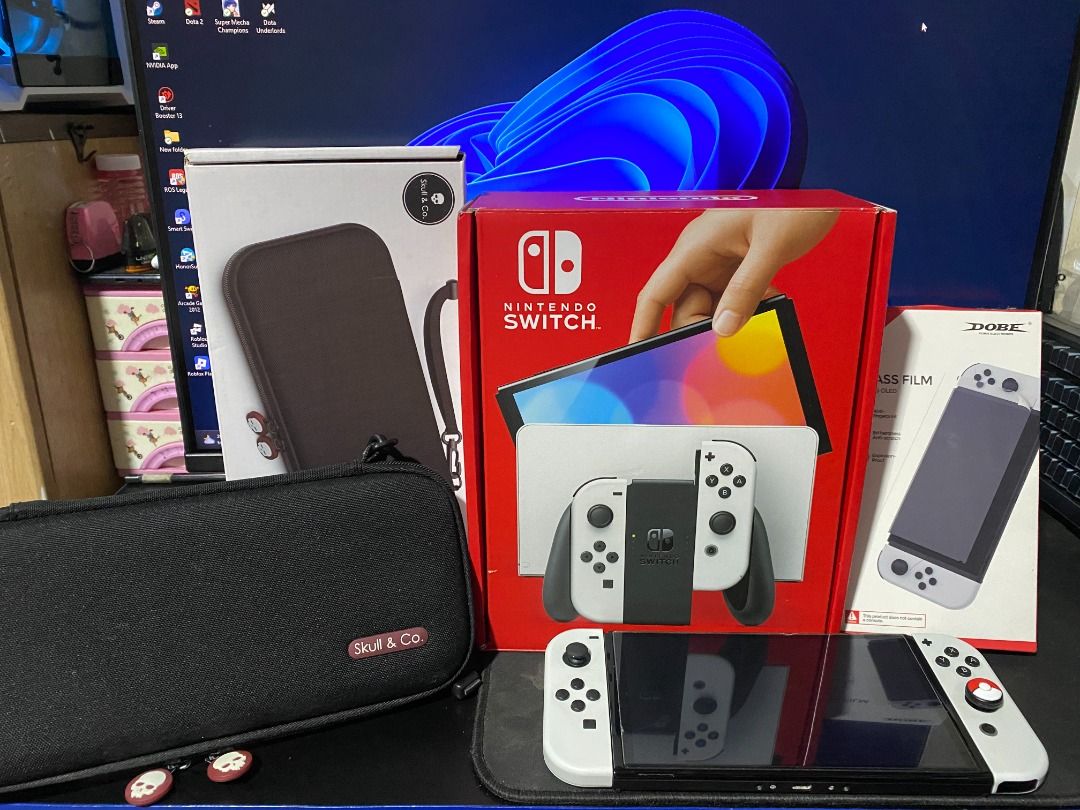 Nintendo Switch OLED White Console with Case, Accessories and Games (Category: Nintendo) located in Quezon City. Submitted by projectzeroo26 (Listing ID 1465157417, Image 2). Description: Complete Accessories **Console **Joy-Con L&R **Joy-Con Straps **HDMI Cable **Switch Dock w/ lan port **Joy-Con Grip **Nintendo Switch AC Adapter **Original Box **Skull&Co. EDC Case **Dobe Glass Film Protector Comes with Red Dead Redemption (Physical Game) and Po