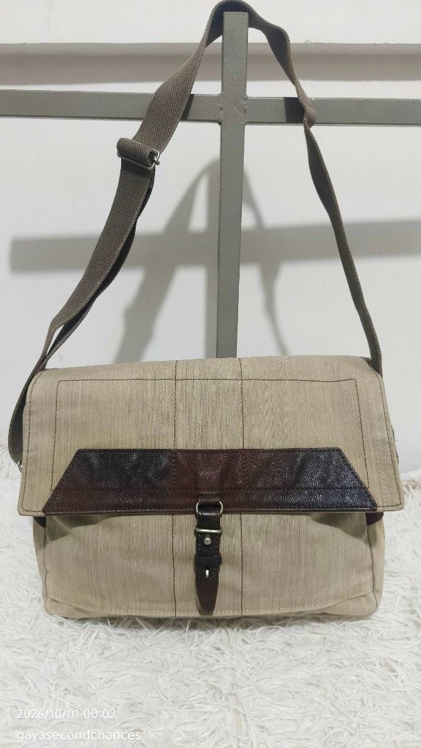 NO CATEGORY CANVAS CROSSBODY MESSENGER BAG (Category: Sling Bags) located in Kalibo. Submitted by secondchances.thriftsh8p (Listing ID 1465134457, Image 1). Description: - Color & Material: Tan canvas with stylish brown leather accents - Closure: Secure flap closure - Strap: Adjustable canvas shoulder strap with sturdy metal hardware - Pockets: Convenient back snap-button pocket for quick access - Design: Structured boxy shape with panel stitchin