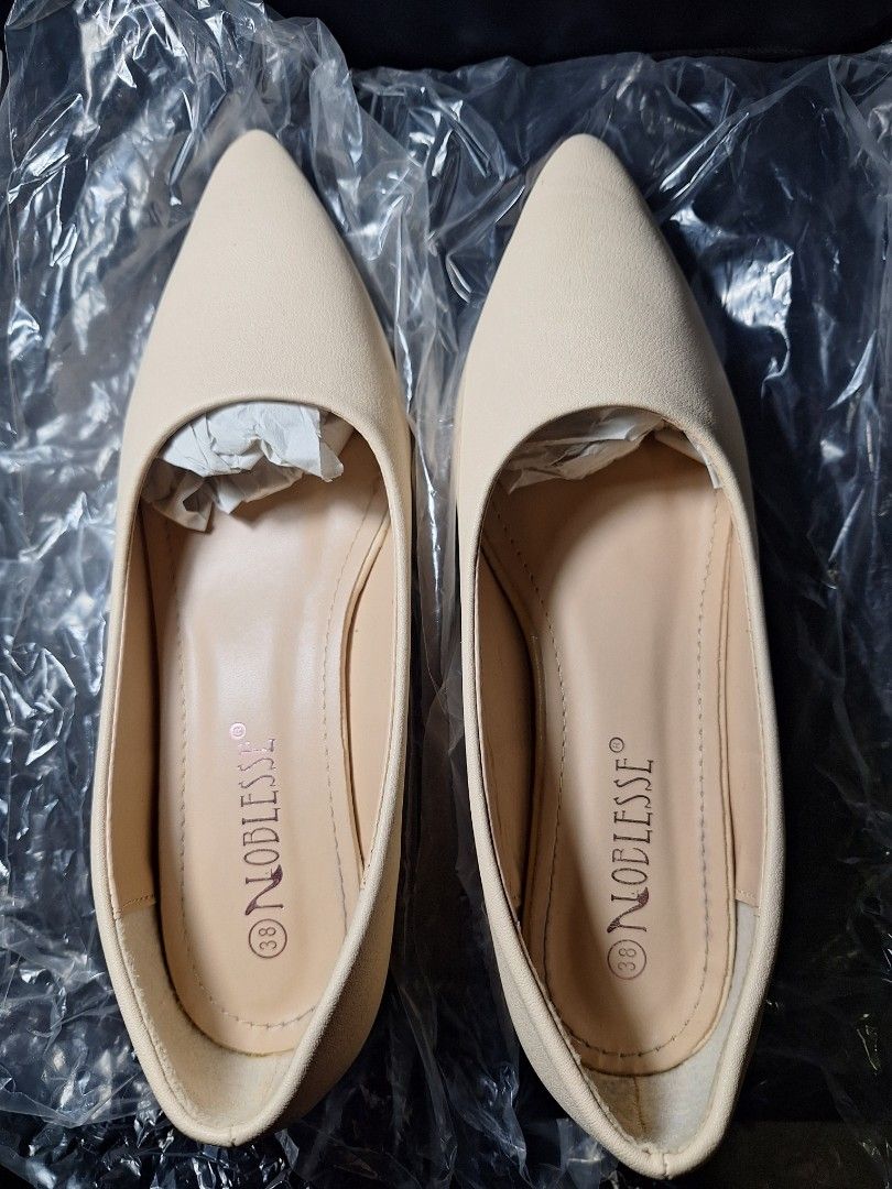 Noblesse Beige Pointed Toe Flat Shoes Size 38 (Category: Flats & Sandals) located in Santiago. Submitted by siobetann (Listing ID 1464991957, Image 3). Description: - Brand: Noblesse - Color: Beige - Style: Pointed toe flats with low block heels and slip-on design - Comfort: Cream padded insoles for extra comfort - Finish: Smooth matte finish - Condition: Pristine with clean soles/edges and original toe paper stuffing.